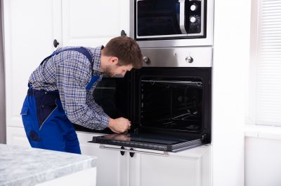 Technician Installing Stove